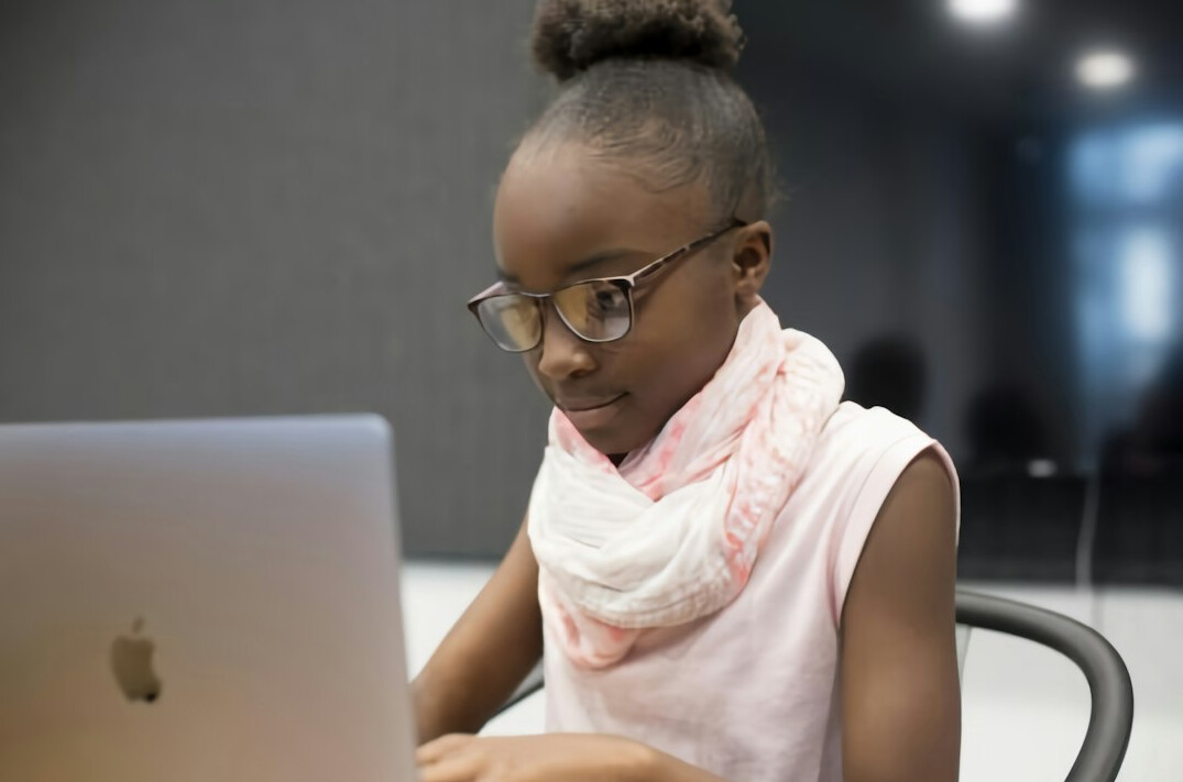 young person coding on laptop