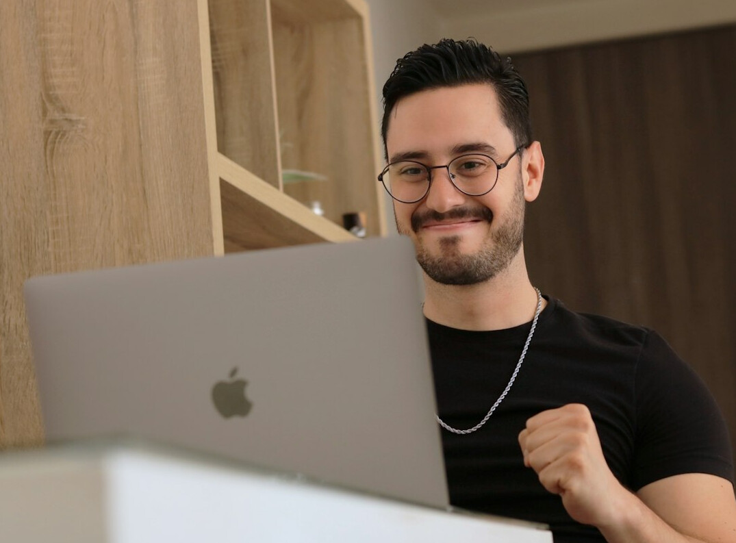 young man celebrating coding success