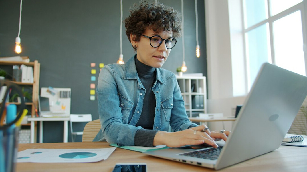 young professional learning to code on laptop